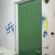 A swastika spray-painted on the wall of a refugee center in reconstruction in Tjörnap, southern Sweden. Arson was attempted here on Oct. 29, 2015.